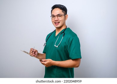 Cheerful Friendly Asian Male Physician, Doctor With Clipboard During Daily Checkup, Standing Over Isolated White Background