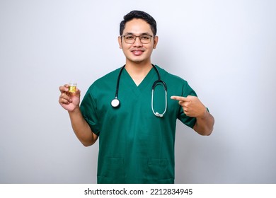 Cheerful Friendly Asian Male Physician, Doctor Pointing And Showing Urine Pot Sample Isolated Over White Background