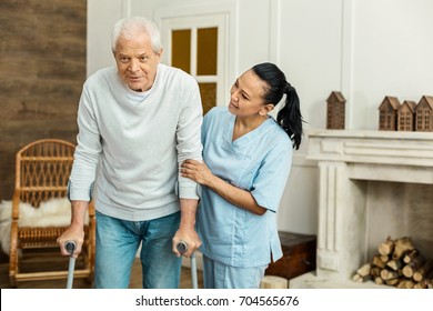 Cheerful Friendly Caregiver Doing Her Job