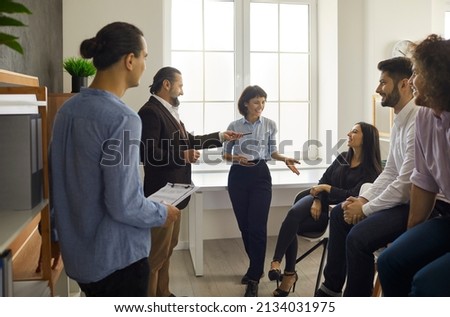 Cheerful and friendly office workers communicate with each other by telling stories and discussing their work during the break. Concept of business, people, teamwork and friendship. Foto stock © 