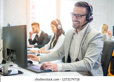 Cheerful Friendly Online Technical Operator Agent With Headphones And Microphone Talking With Client In Customer Support Office