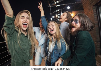 Cheerful Friends Dancing All Night Long During Their Party On A Loft Balcony