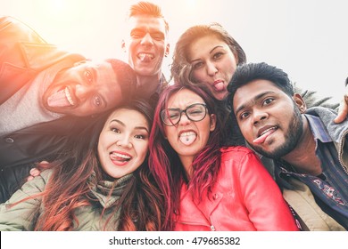 Cheerful Friends From Different Countries And Races Taking Selfie With Back Lighting - Happy Youth Concept With Young People Having Fun Together - Main Focus On Bottom Guys - Vintage Retro Filter