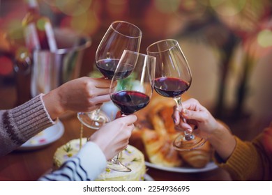 Cheerful friends enjoying home Birthday holiday party. Asian Friends cheering drinking red wine celebrating Christmas or New Year party. - Powered by Shutterstock