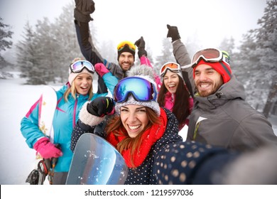 Cheerful Friends With Hands Up On Skiing