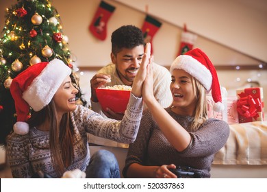 Cheerful Friends Having Fun On Christmas Eve.