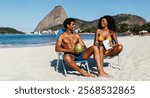 Cheerful friends relax on a sunny beach in Rio de Janeiro. They enjoy drinks, snacks and conversation with a stunning view of the ocean and the iconic praia do flamengo landscape.