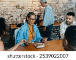 A cheerful gathering of coworkers at a modern office, highlighting connection and diversity. Laughter and conversation over a shared meal create a warm and welcoming atmosphere.