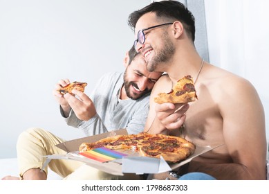 Cheerful Gay Couple Eating Pizza At Home