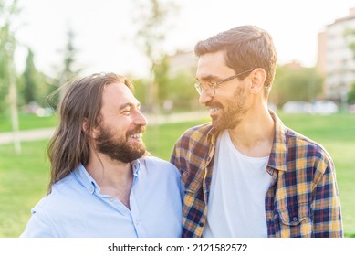 Cheerful Gay Couple Looking At Each Other In The Park