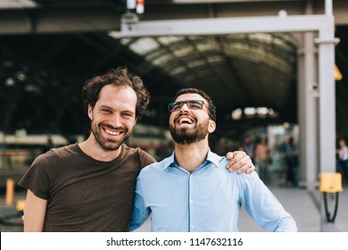 Cheerful German And Syrian Men Laughing