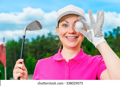 cheerful girl in a baseball cap with the equipment for golf