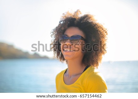 Cheerful girl at the beach, smiling a lot