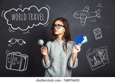 Cheerful Girl Holding Passport, Plane Ticket And Globe Before Grey Background, Indoor Travel Concept