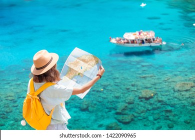 Cheerful Girl With A Map Exploring Interesting Places To Travel By Ferry Or Rented Boat Or Yacht In The Azure Gulf Of The Mediterranean Sea