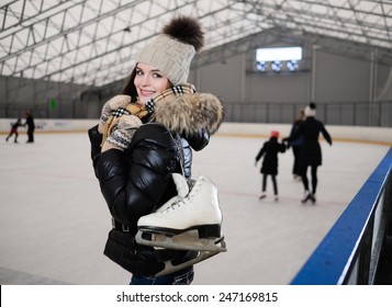 Cheerful Girl With Skates On Ice Skating Rink 