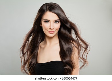 Cheerful Girl with Windy Hair. Fashion Model Woman on Grey Banner Background