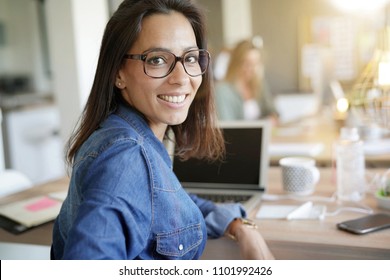 Cheerful girl working in co-working office