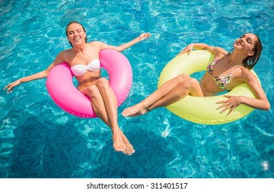 Cheerful Girlfriends Are Having Fun In Swimming Pool.