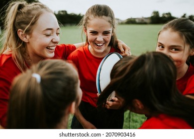 Cheerful girlrsquo;s rugby team talking after the game