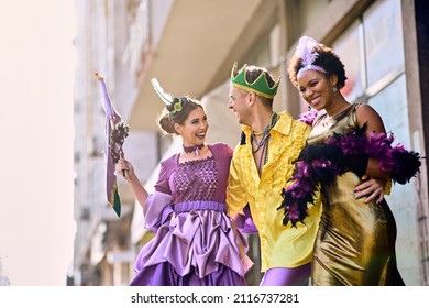 Cheerful Group Of Friends In Carnival Costumes Having Fun On The Street During Mardi Gras Festival.