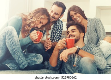 Cheerful Group Of Friends Having Fun At Home,drinking Coffee And Enjoying Together.