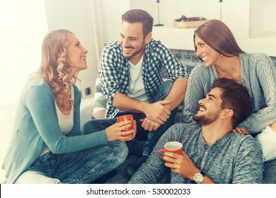 Cheerful Group Of Friends Having Fun At Home,drinking Coffee And Enjoying Together.