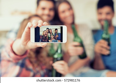 Cheerful group of friends having fun at home,taking selfie. - Powered by Shutterstock