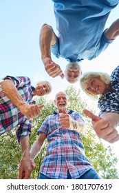 Cheerful Group Of Seniors With Thumbs Up In Summer Vacation