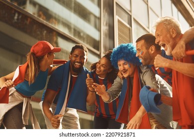 Cheerful Group Of Soccer Fans Shouting And Singing On The Street. 