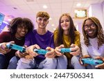 A cheerful group of teens shares a fun moment playing video games at a local gaming hub.