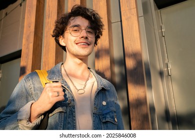 Cheerful Guy With Backpack Looking At You With Smile While Standing Outdoor