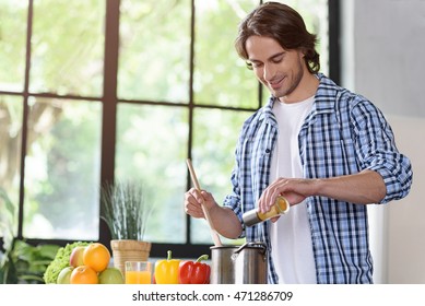 Cheerful Guy Cooking At Home