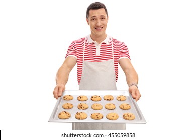 Cheerful Guy Holding A Tray With Homemade Chocolate Chip Cookies Isolated On White Background