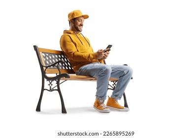 Cheerful guy sitting on a bench and using a smartphone isolated on white background