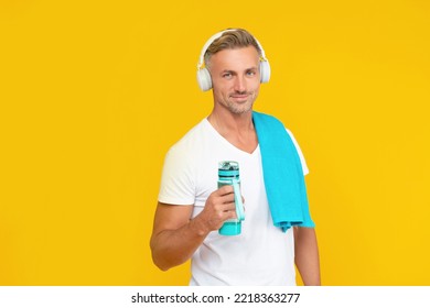 Cheerful Guy With Sport Bottle For Healthy Lifestyle Isolated On Yellow. Guy Holding Bottle