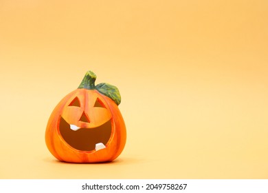 Cheerful halloween pumpkin on an orange background. Halloween background with place for text. Nhe day of the Dead. Autumn holiday