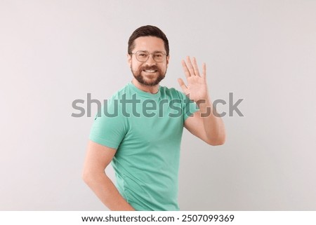 Image, Stock Photo Funny young man on brick wall with open hands