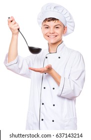 Cheerful Handsome Teen Boy Wearing Chef Uniform. Portrait Of A Happy Cute Male Child Cook With Black Ladle, Isolated On White Background. Food And Cooking Concept.