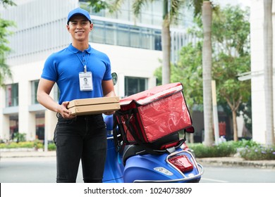 Cheerful Handsome Young Delivery Guy Holding Boxes With Hot Pizza