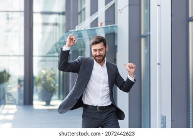 Cheerful Happy Business Man Dancing Walk The City Street Background A Modern Office Building Outside, Outdoors Funny Successful Businessman In Suit Celebtes Victory