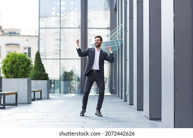 Cheerful Happy Business Man Dancing Walk The City Street Background A Modern Office Building Outside, Outdoors Funny Successful Businessman In Suit Celebtes Victory