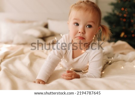 Similar – Little girl smiling lying over the bed