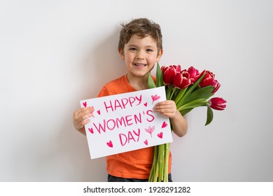Cheerful happy child with tulips flower bouquet. Smiling little boy on white background.  International Women's Day concept - Shutterstock ID 1928291282