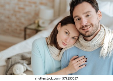 Cheerful Happy Couple Sitting At Home