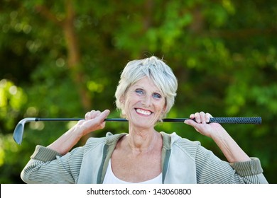 Cheerful Happy Older Woman With A Golf Stick In The Golf Club.