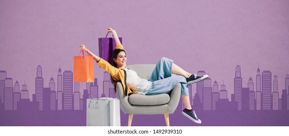 Cheerful Happy Shopaholic Woman Holding Lots Of Shopping Bags And Resting On An Armachair, City Skyline In The Background