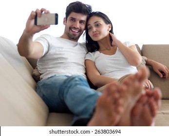 Cheerful Happy Young Couple Making Selfie Together At Home