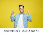 Cheerful happy young man posing isolated on bright yellow background