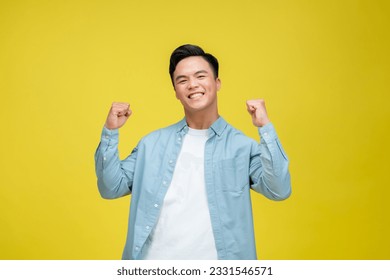 Cheerful happy young man posing isolated on bright yellow background - Shutterstock ID 2331546571